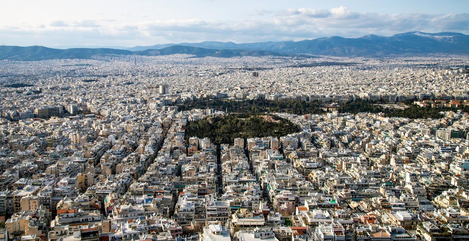 An Aerial View of a City with Mountains in the Background Lr9w 8srsv4